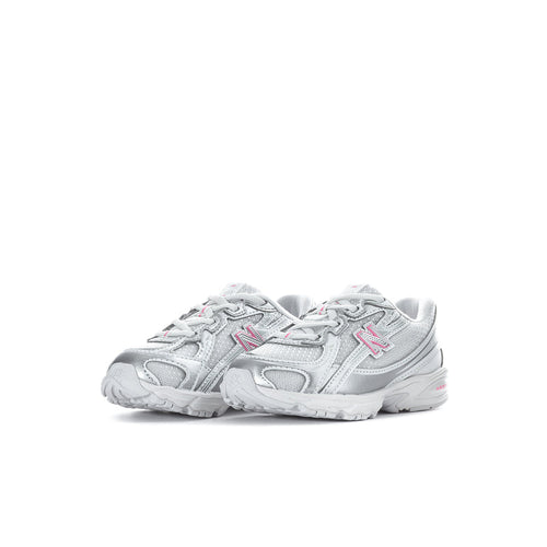 Silver toddler sneaker with pink N logo and padded collar, rear side view.