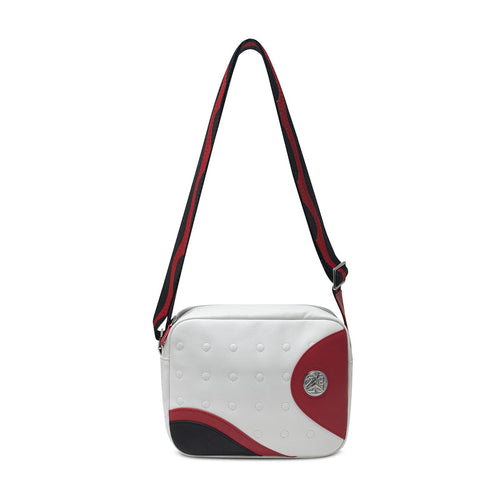 White crossbody messenger bag with adjustable straps and round red logo patch
