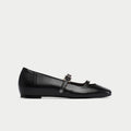 Black platform shoe with a strap on a white background