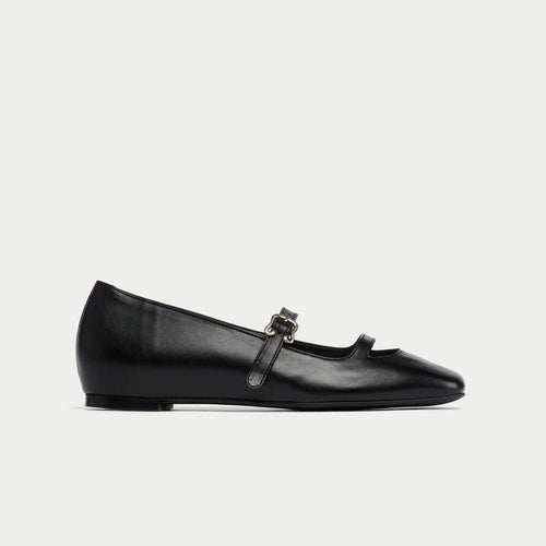 Black platform shoe with a strap on a white background
