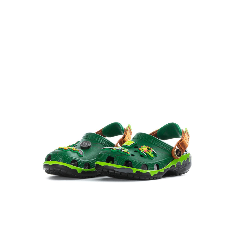 Kids green clog with side TMNT character print, orange-brown strap and neon sole