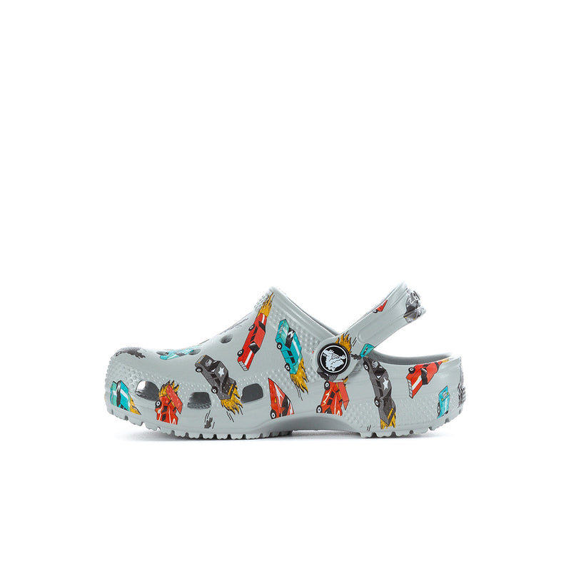 Toddler light gray clog angled side view with race car graphics and round logo