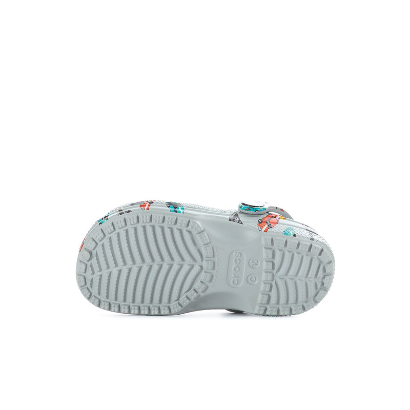 Toddler clog outsole view with light gray tread; race car print at edge