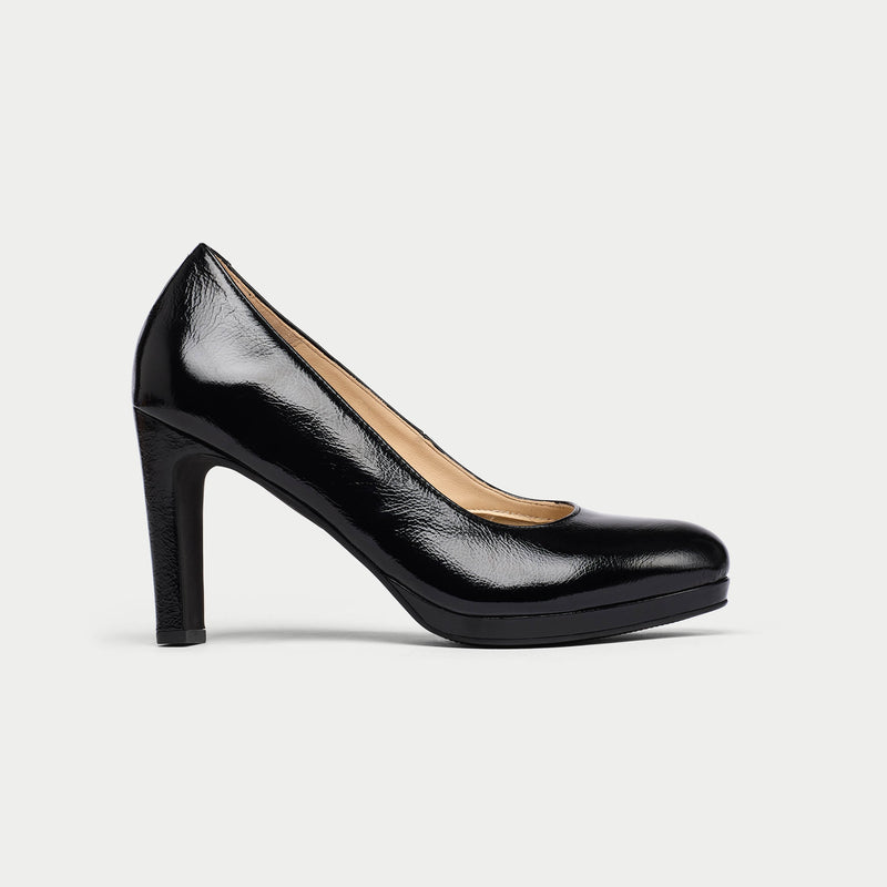 Black high-heeled shoe on a light gray background