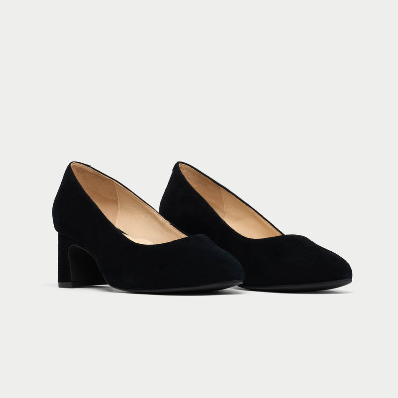 Pair of black high-heeled shoes on a light gray background