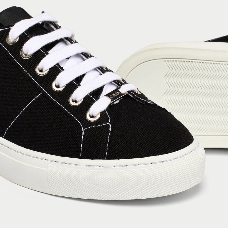 Luna black trainer shoe tip view