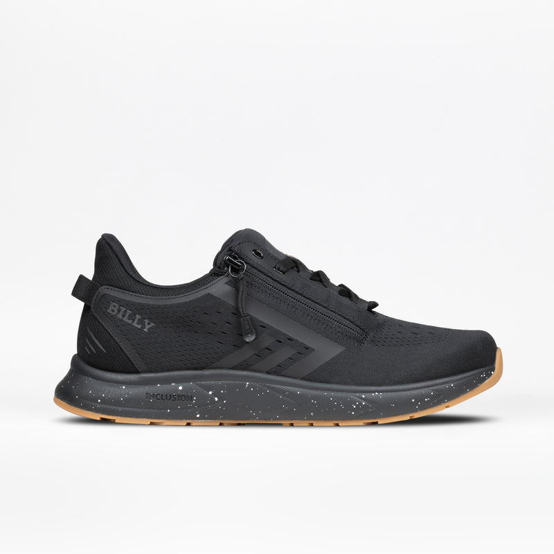The Men's Black/Black/Gum BILLY Sport Inclusion DZ1 by BILLY Footwear is a black athletic sneaker for men featuring double zippers, a speckled black-and-white midsole, tan gum outsole, and BILLY branding on the heel, shown on a white background.