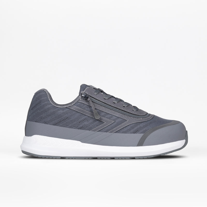 The Men's Charcoal BILLY Goat by BILLY Footwear is a gray adaptive shoe with a white sole, lace-up front, and side zipper for easy wear, shown on a plain white background.