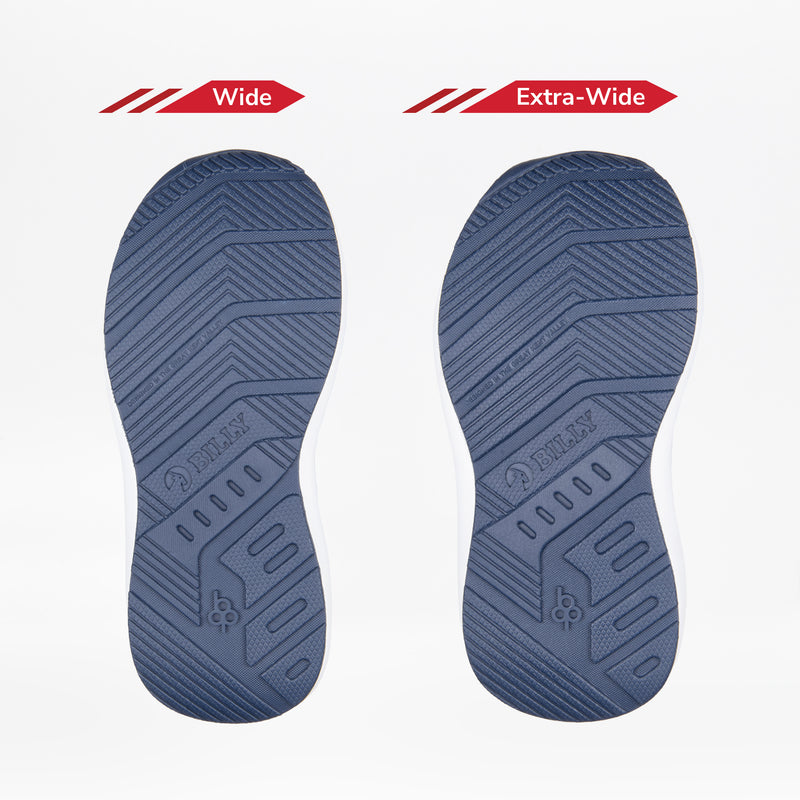 Two blue soles from the Navy/Green BILLY Goat by BILLY Footwear are shown side by side—one labeled Wide and the other Extra-Wide—demonstrating the width options of these easy on-and-off orthotic shoes for kids.