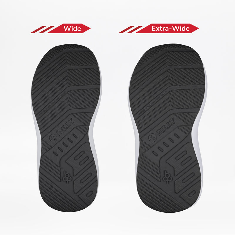 Two black outsoles from the BILLY Footwear White/Black BILLY Goat Hoop are shown side by side on a white background: Wide (left) and Extra-Wide (right), showing width and tread differences—perfect for adaptive or orthotic kids’ shoes.
