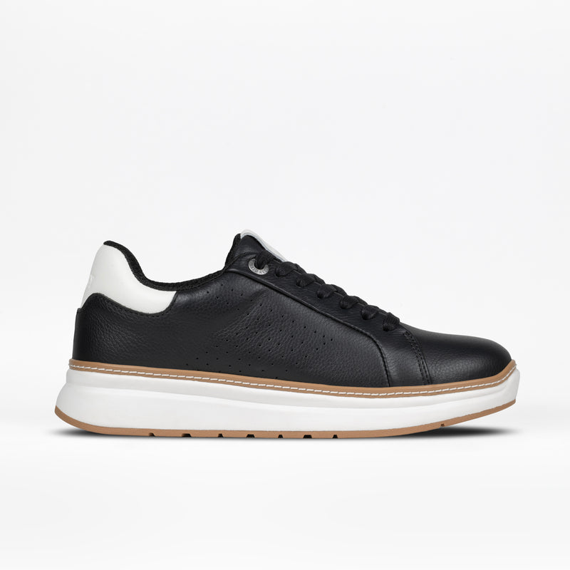 The Women's Black Leather BILLY Comfort Luxe sneaker by BILLY Footwear, shown in side profile on a plain white background, features black leather, black laces, a white sole, and a white heel accent.