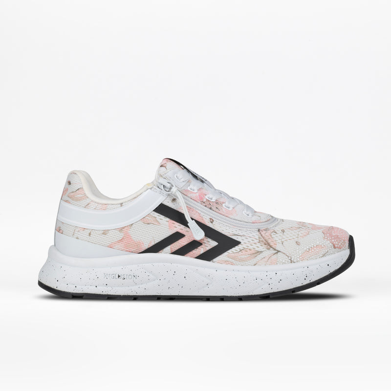 The Women's Stone Floral BILLY Sport Inclusion by BILLY Footwear is a white athletic zipper shoe for women with pale pink floral patterns, black stripes and accents, and a speckled sole. Cushioned insole for comfort. Side view on white background.